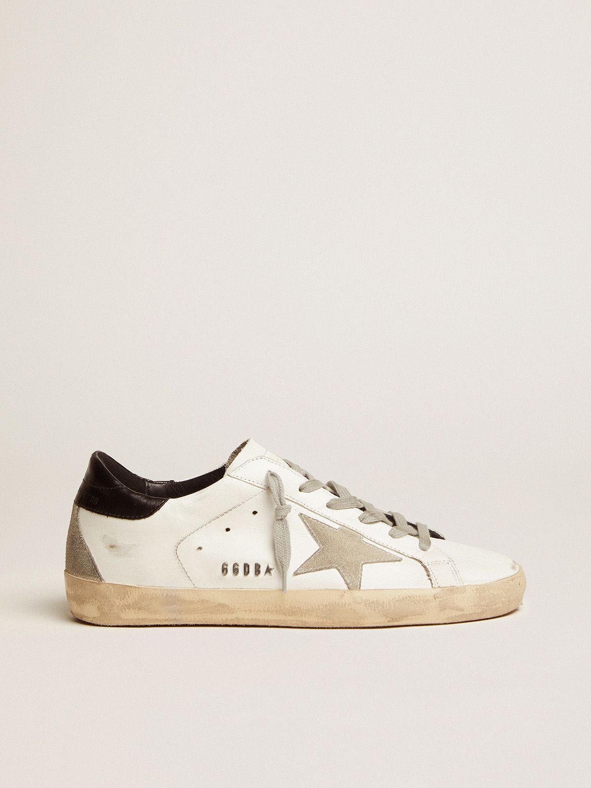 Sup-S sneakers with black heel tab and metal stud lettering