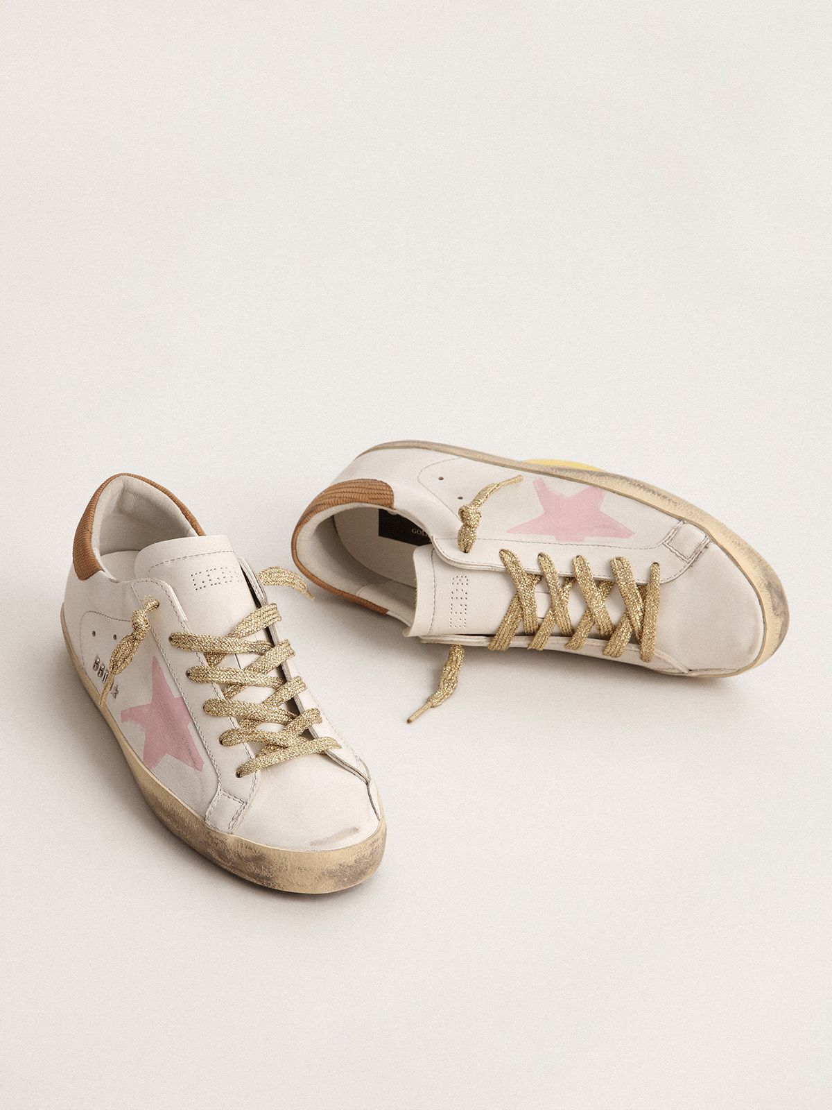 Sup-S LTD sneakers with pink screen printed star and snake-print leather heel tab