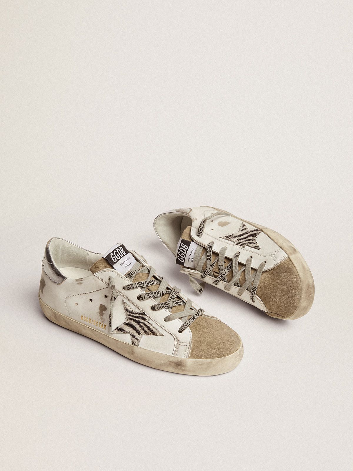 Sup-S sneakers with silver laminated leather heel tab and zebra-print pony skin star